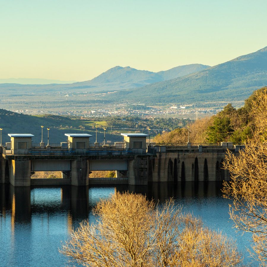 A bridge spans across the water during autumn in Cercedilla, Spain.