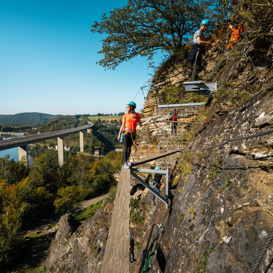 An adventurer takes on a cliffside challenge in Dinant, Belgium.