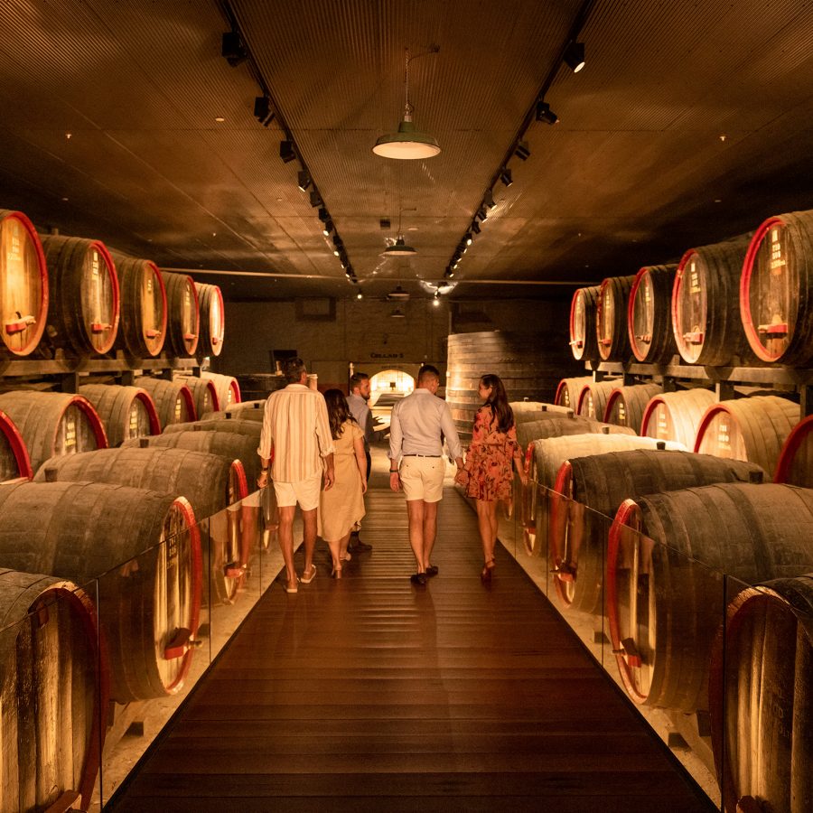 People tour a wine cellar at Magill Estate. 