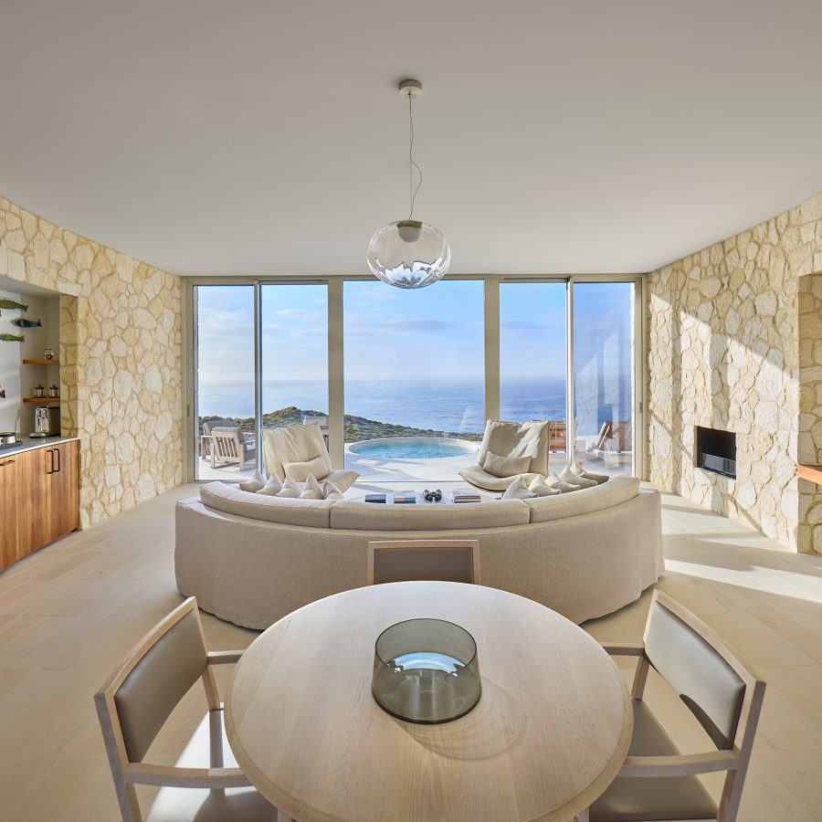 The living and dining area at Southern Ocean Lodge is simple and clean with lots of natural light.  