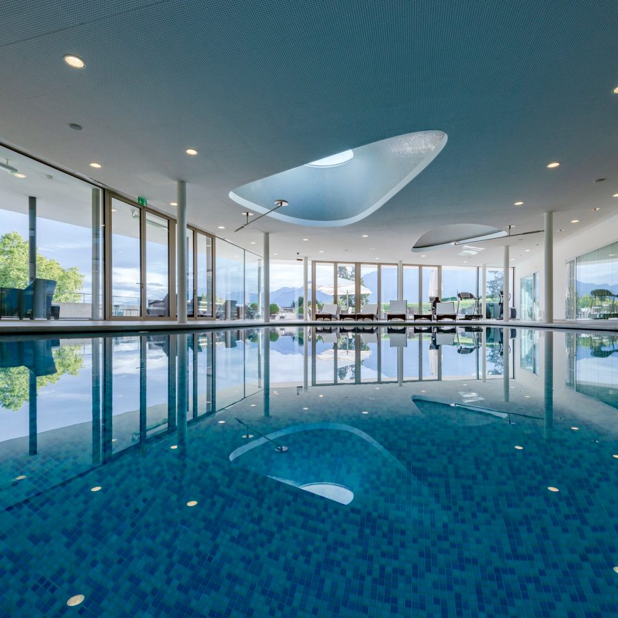 View of the blue swimming pool and triangular skylight at Clinique La Prairie in Montreaux, Switzerland.