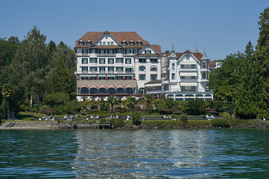 Exterior daytime view of Chenot Palace Weggis on the shore of Lake Lucerne. 