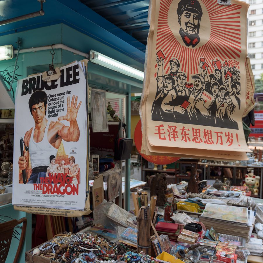 A stall selling a Bruce Lee poster and vintage knicknacks on Upper Lascar Row.