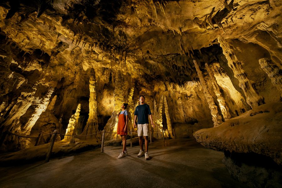 A couple walking and viewing inside a cave at the Rainforest Wild Asia, Singapore