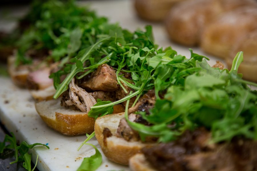 A table of openfaced porchetta sandwich in a line, served at Roli Roti in San Francisco 