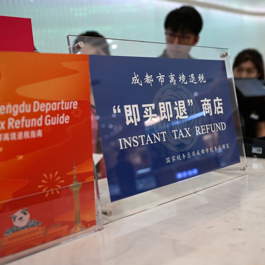 A counter with a sign stating “Instant Tax Refund” and some Chengdu tax refund leaflets