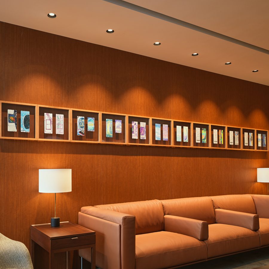 William Lim’s boarding pass drawings hanging above a sofa in Cathay Pacific’s Beijing lounge.