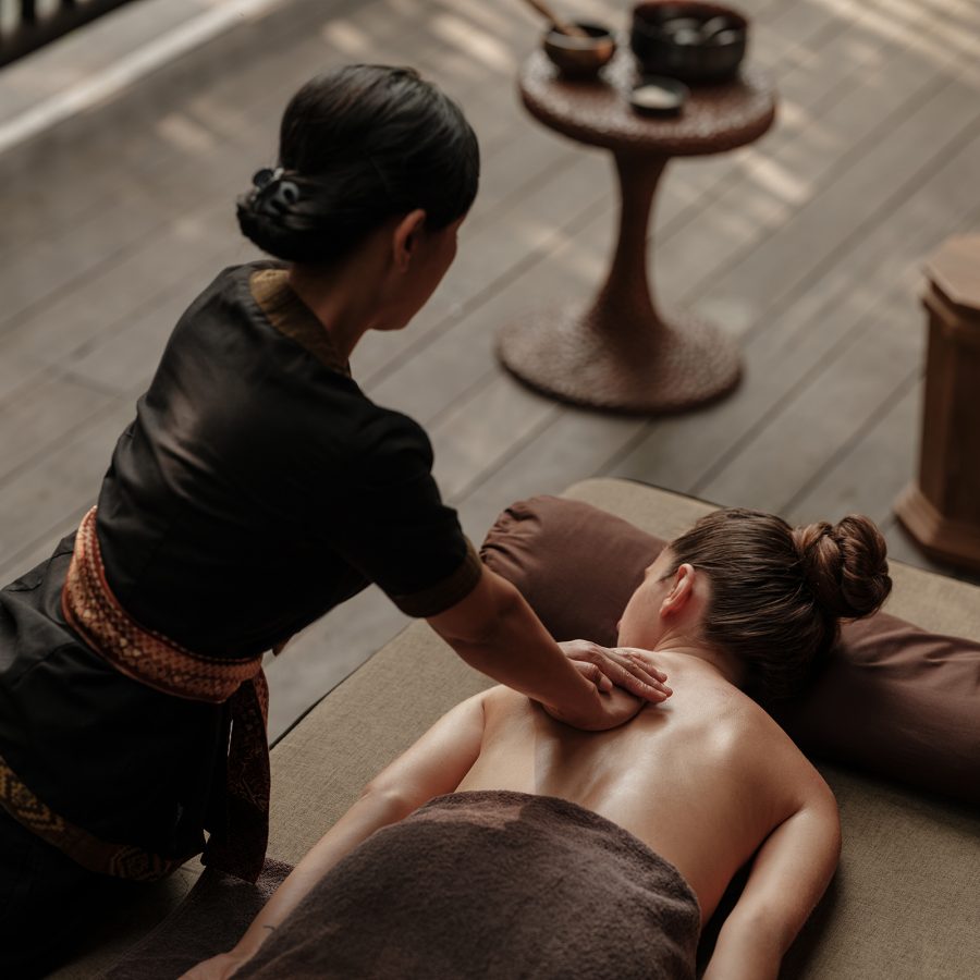 A massage therapist giving a woman a massage at the Capella Ubud spa. 