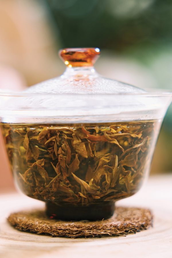 Close up on tea brewing in clear glassware.