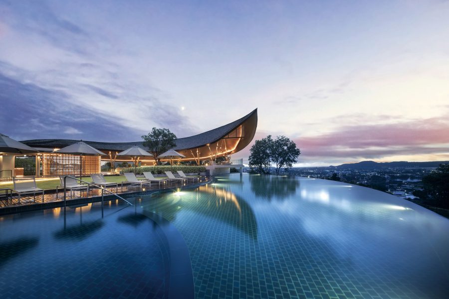 The outdoor pool at Noku Phuket at dusk.