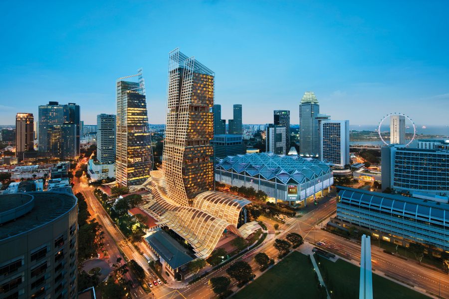 Exterior of the JW Marriott Singapore South Beach hotel at twilight.