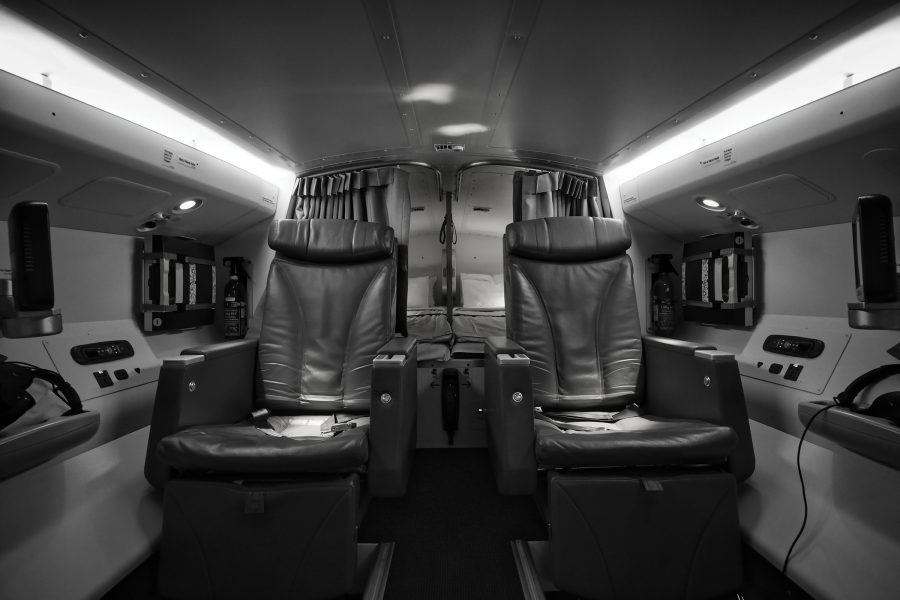 Two black reclining seats in the pilot rest area on board Cathay Pacific aircraft.