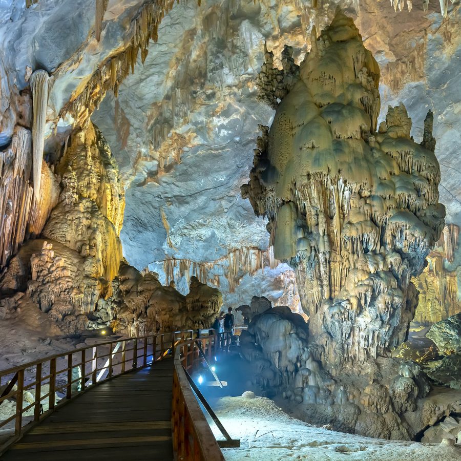 A wooden boardwalk extends deep into a cave teeming with stalactites in Phong Nha-Ke Bang National Park. 