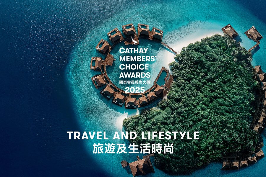 Aerial shot of overwater bungalows and trees.