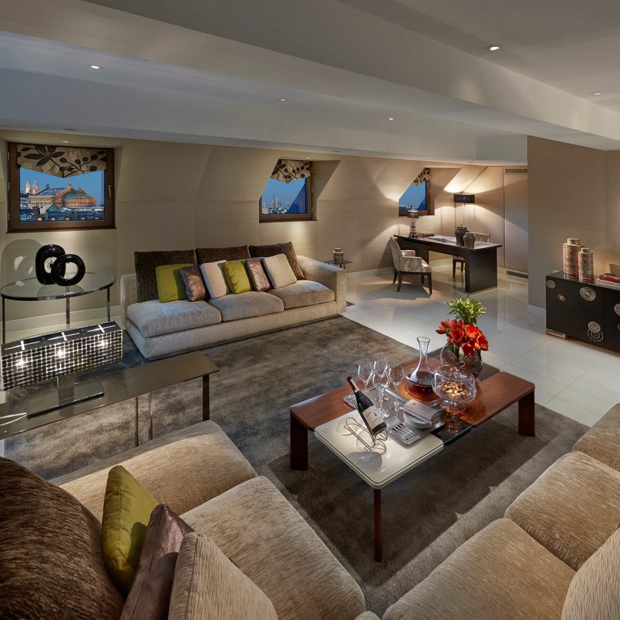A guestroom in Mandarin Oriental, Paris, with several couches and tables.