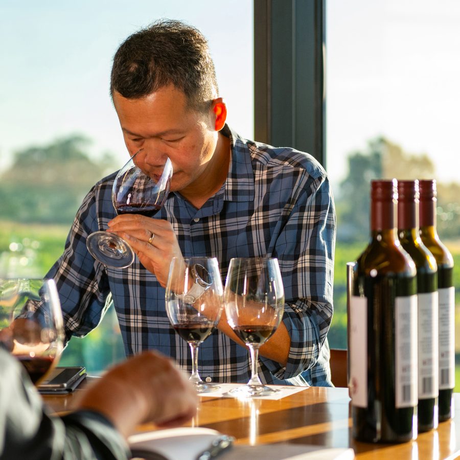 Ronald Khoo, Wine, Spirits and Beverages Manager at Cathay, smells a glass of wine.  