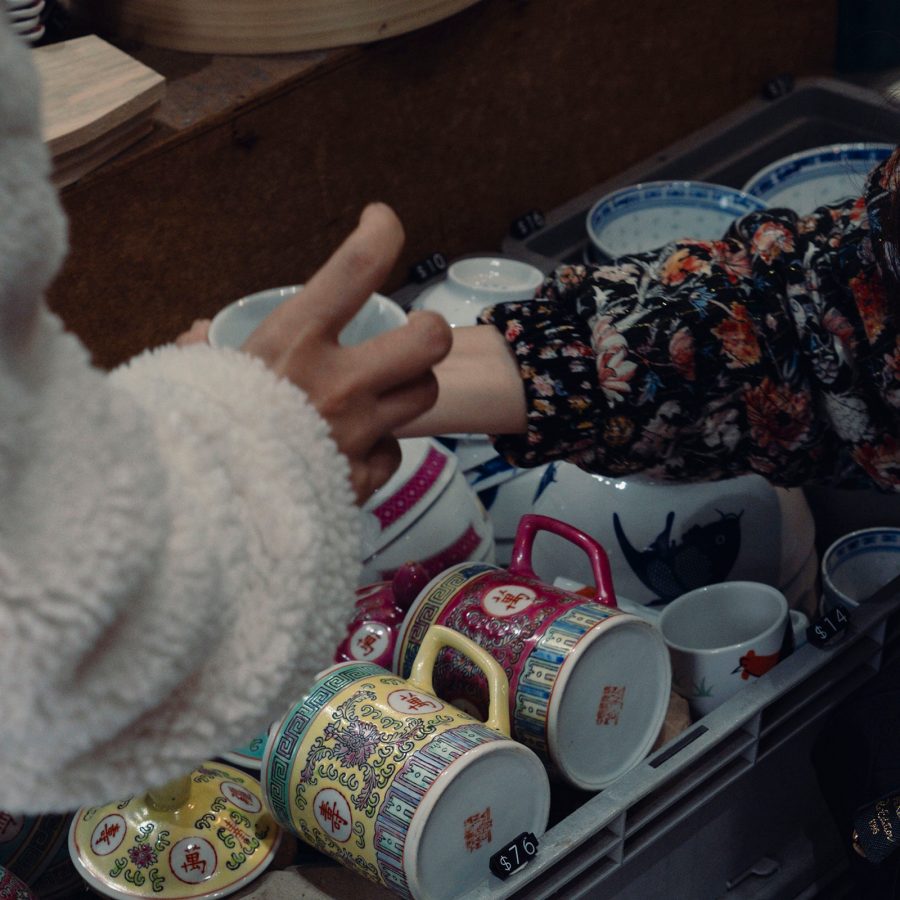 People reaching into a basket full of traditional ceramics in Hakdei in Hong Kong. 
