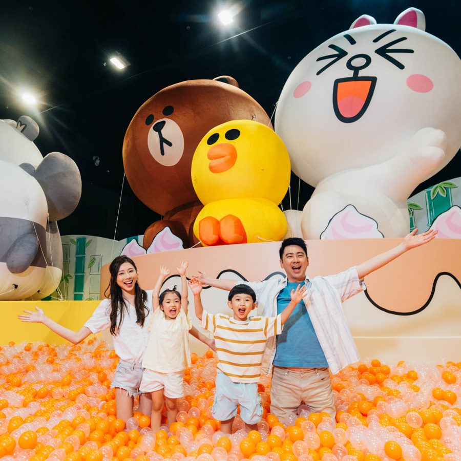 A family poses for the camera as they stand in Ocean Park’s Line Friends-themed ball pit.