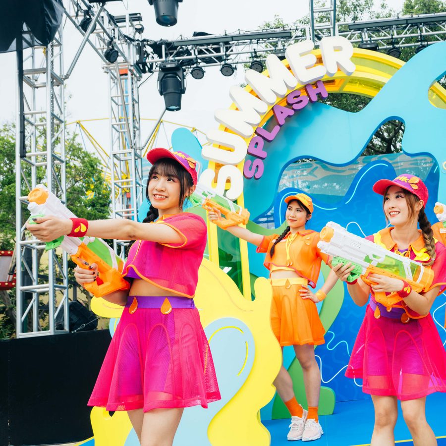 Ocean Park staff dressed in bright colours hold up water guns as part of the park’s summer activities.  