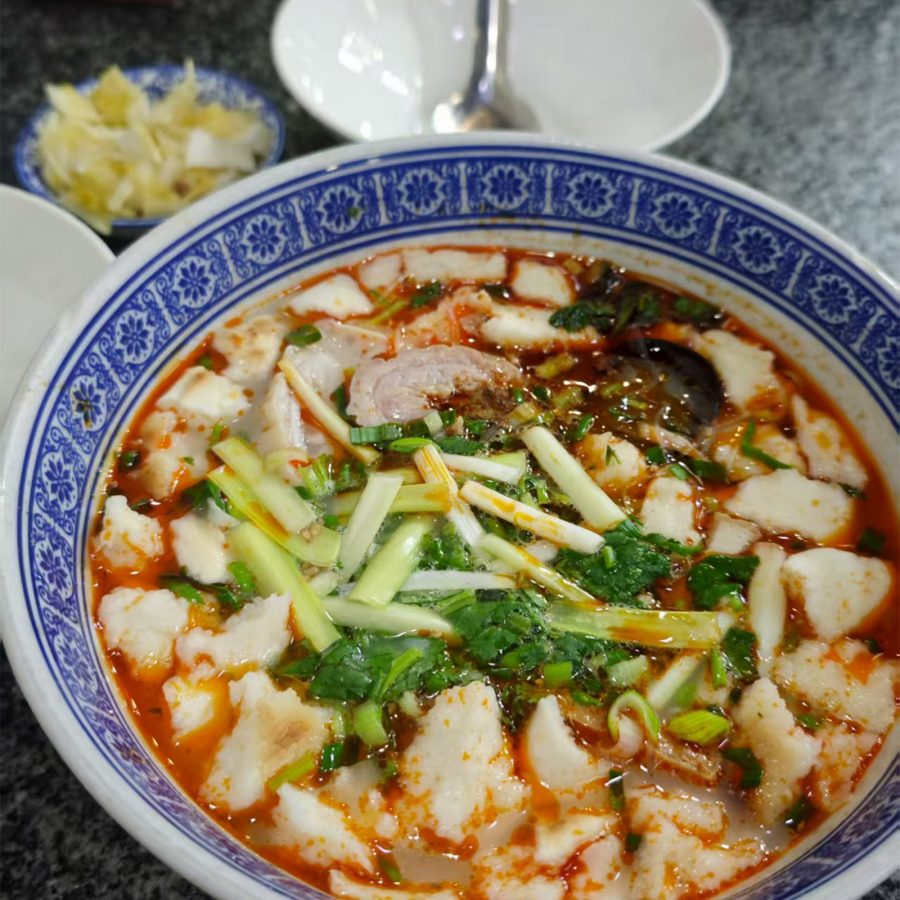 Close up on a bowl of shredded flatbread and pig intestines in soup in Xi’an.