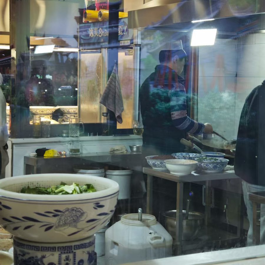 Man cooking a dish over a wok in Xi’an.