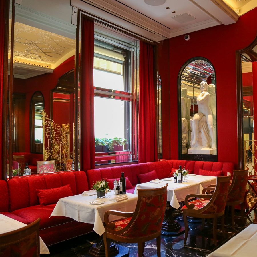 A plush red dining room at Hotel Hassler Roma.