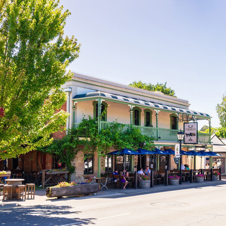 The exterior of a building in East End is decorated with plants and outdoor seating.