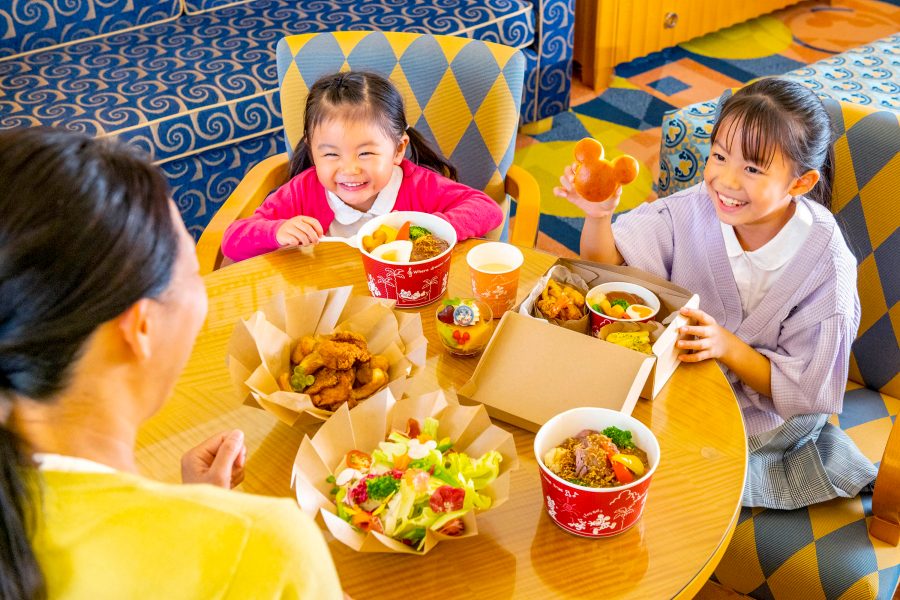 A family with two young girls enjoying a meal at the Disney Ambassador Hotel, Tokyo restaurant.