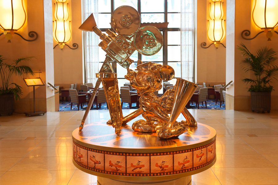 An interior view of the Disney Ambassador Hotel, Tokyo lobby featuring a statue of a Hollywood-themed Mickey Mouse.