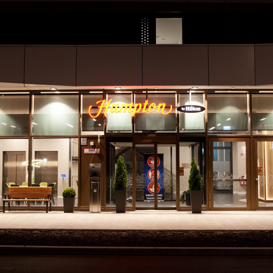 An exterior view of Hilton Munich City hotel entrance at night.