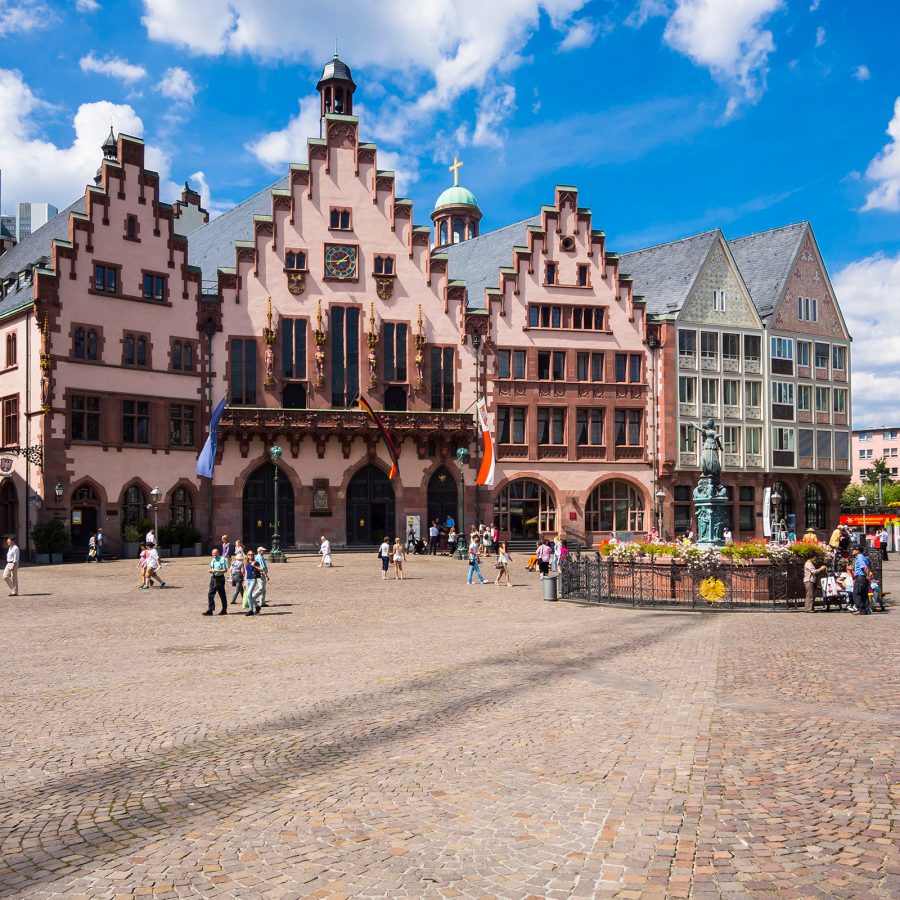 Exterior view of Romerberg square with old buildings and the iconic Lady Justice statue.