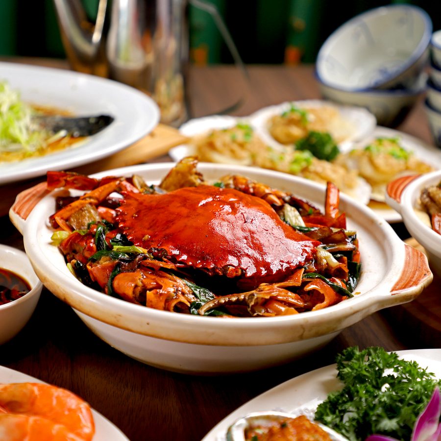 A crab dish takes centre stage on a table among other seafood dishes like steamed fish and shrimps at ChorLand.