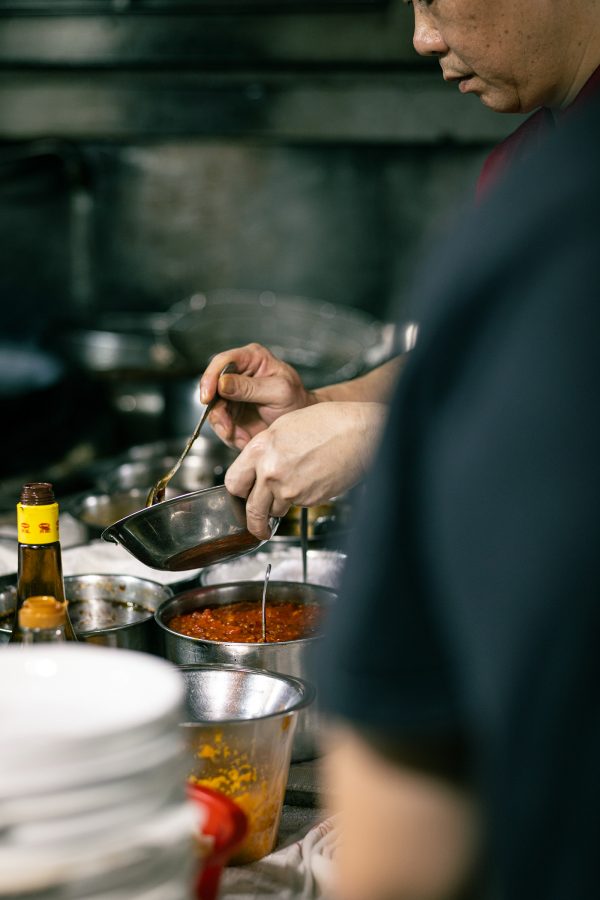 A chef prepares a sauce inside the kitchen of Oi Man Sang, a dai pai dong in Hong Kong. 