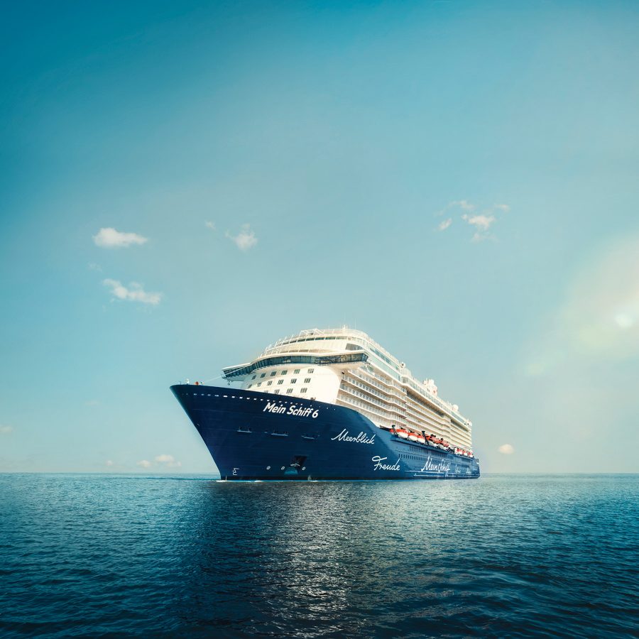 A view of Mein Schiff cruise sailing the blue ocean under a blue sky