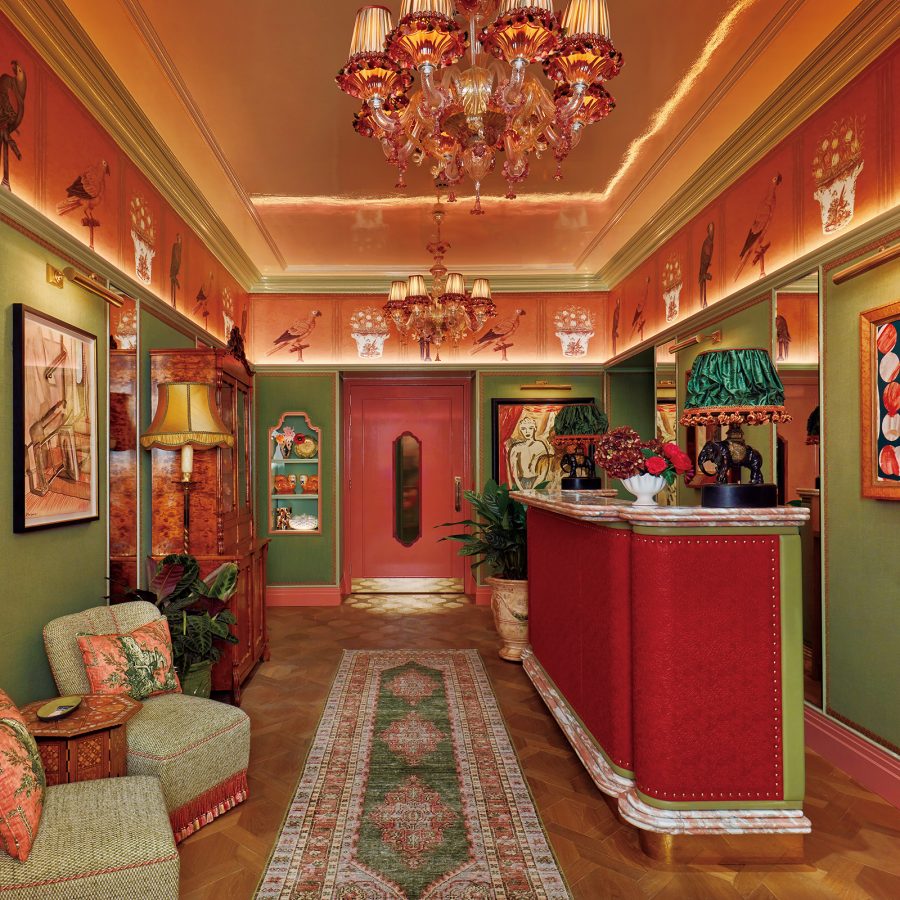 An indoor space within Broadwick Soho is lavishly decorated with artwork, carpets, and busy-looking colours and furniture.