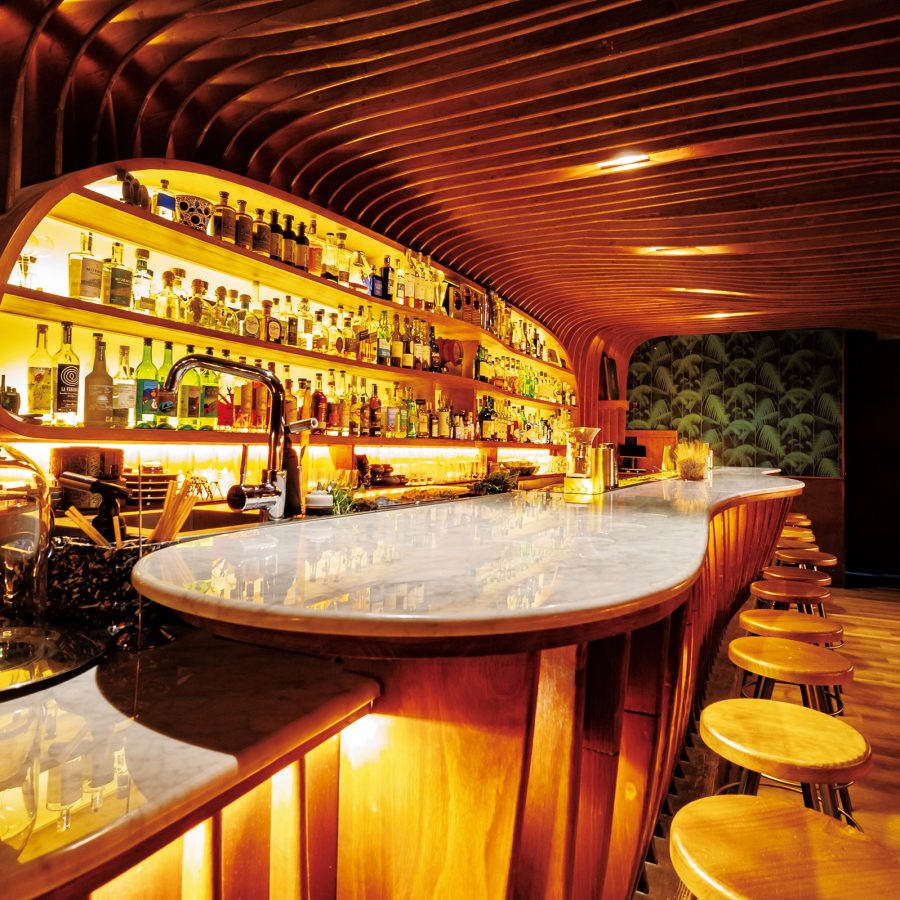 The interior of Paradiso features a wide bar area decorated with a wooden theme.