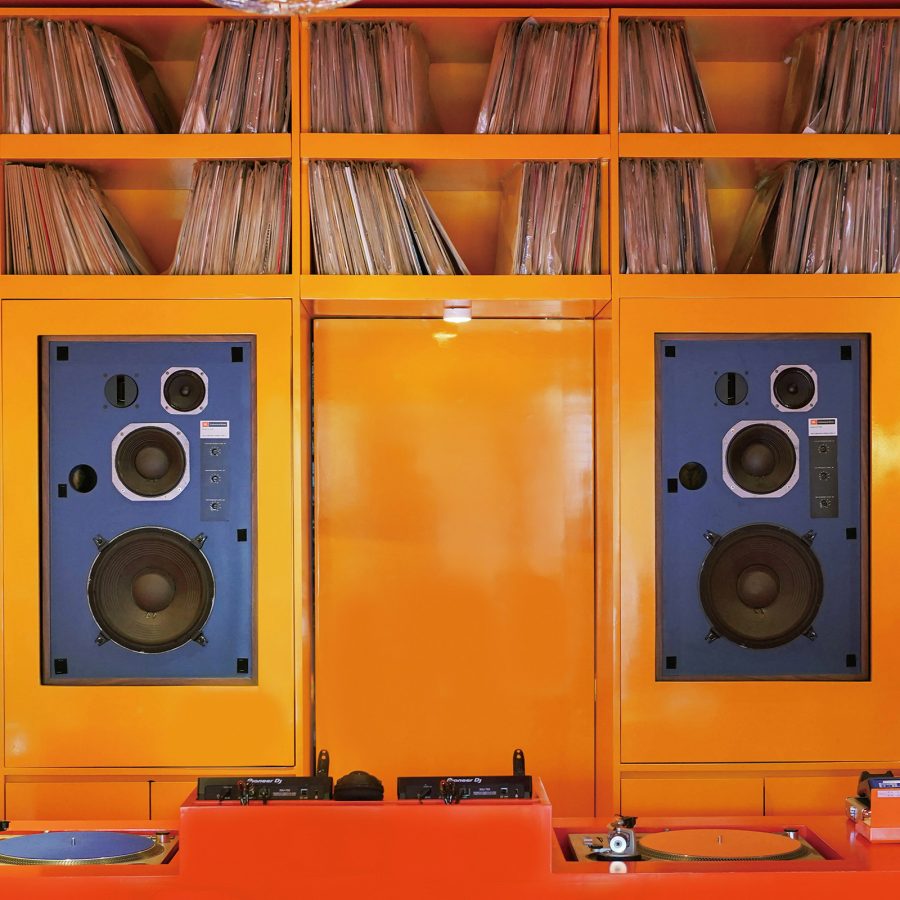A stereo and vinyl system has been installed alongside shelves full of records.