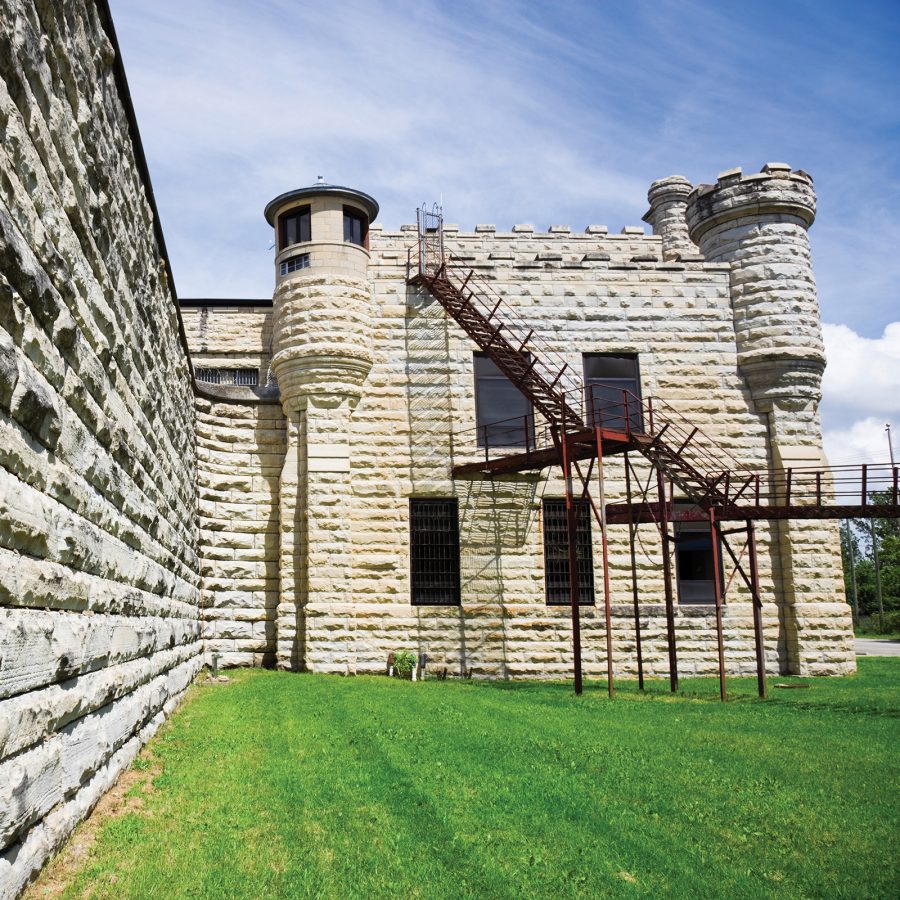 The Old Joliet Prison on a green lawn.
