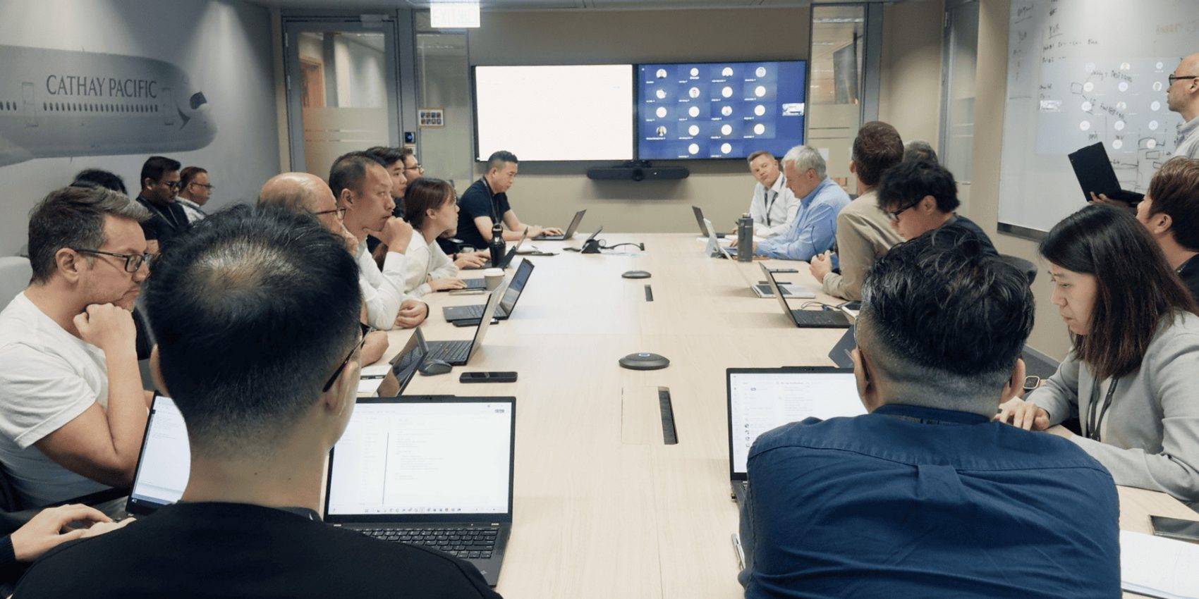 Cathay Pacific's Flight Operations team seated in a conference room at the Integrated Operations Centre, planning for super Typhoon Ragasa.