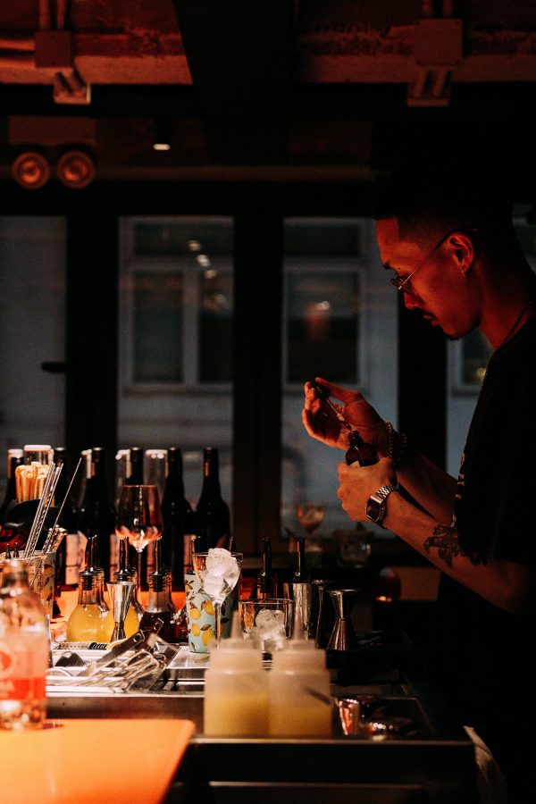 A bartender works with his equipment at AER. 