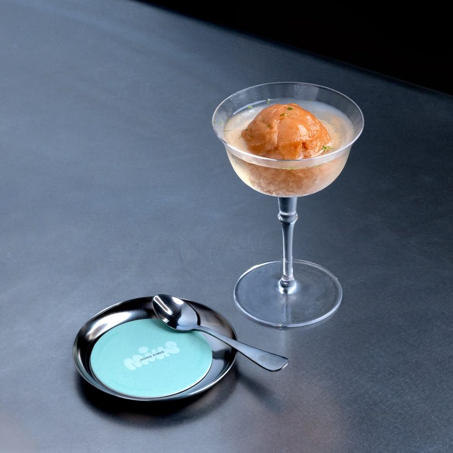 A cocktail glass has been placed on a metal table at Mius.