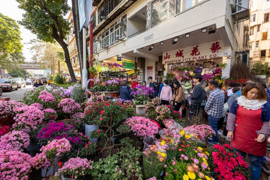 A crowded street of people shopping for fresh flowers at the Flower Market in Prince Edward, Hong Kong