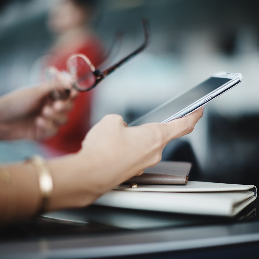 Close up of a passanger using a mobile device.