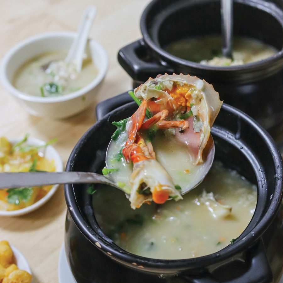 Two claypot congees and a bowl on a table.