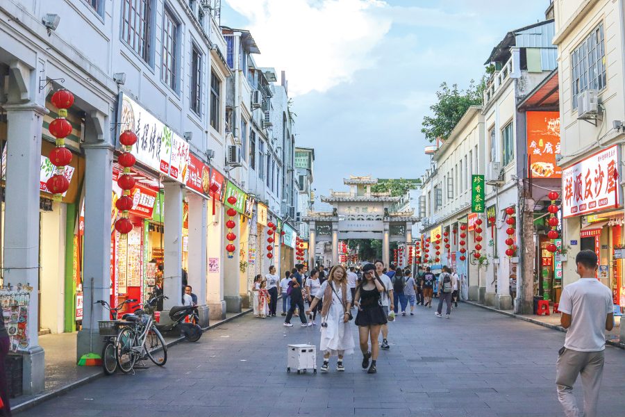 People walking along Paifang Street in the daytime.