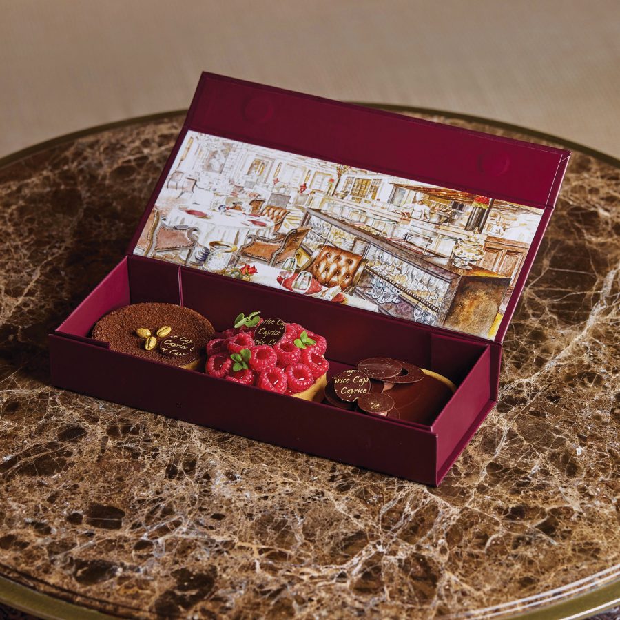 A red box containing three tarts from Caprice, Four Seasons Hong Kong.