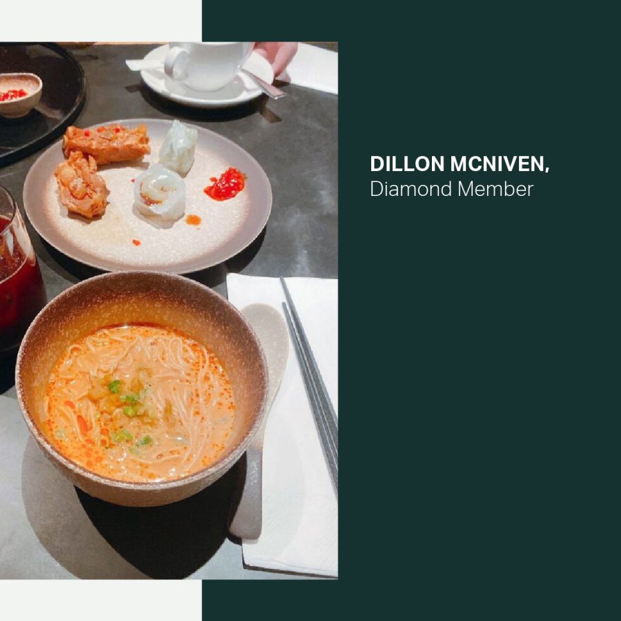 A bowl of dan dan noodles, a plate of dim sum and a glass of fruit juice on a table at Cathay Pacific’s The Pier, First lounge at Hong Kong International Airport.