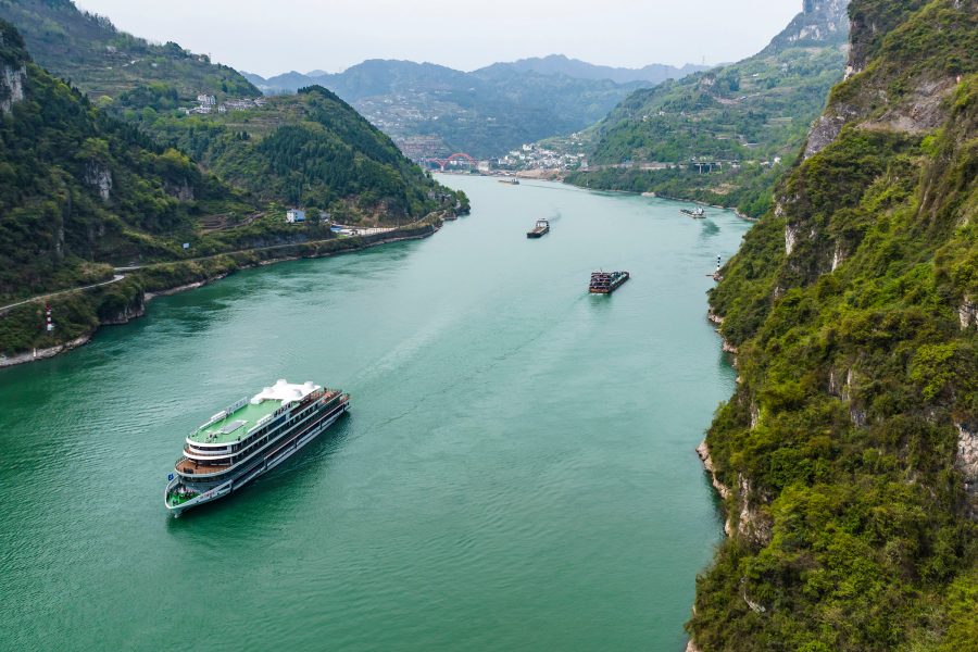  A cruise ship and boats passing the Three Gorges along Yangzte river in China