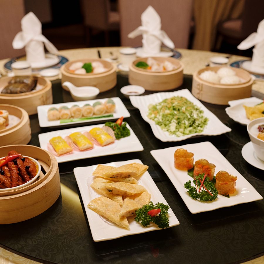 A family spread of various dim sum dishes on a round table, served at Hongtu Hall in Guangzhou, China