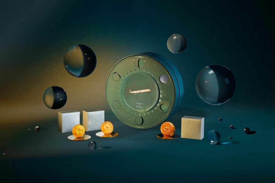 Product image of the Cathay x The Peninsula Boutique Assorted Mini Mooncakes. Bubbles are floating around the individual mooncakes, mooncake boxes and the round keepsake box.